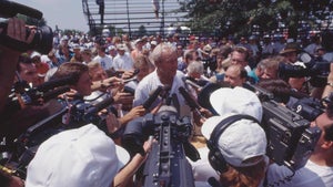 arnold palmer surrounded by press