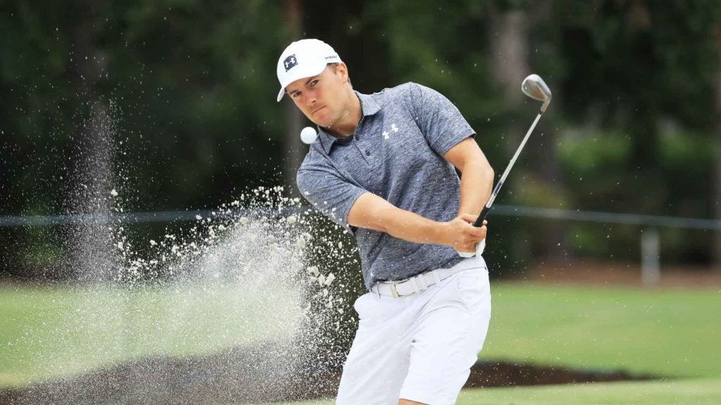 Pro golfer Jordan Spieth hits sand shot