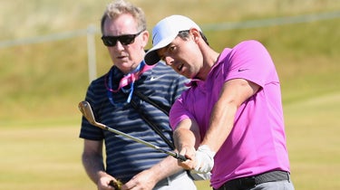 Michael Bannon works with Rory McIlroy before a round.