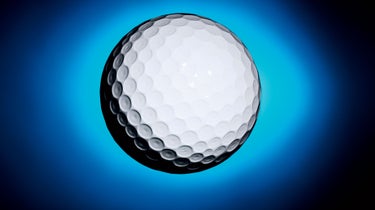 Golf ball on blue background