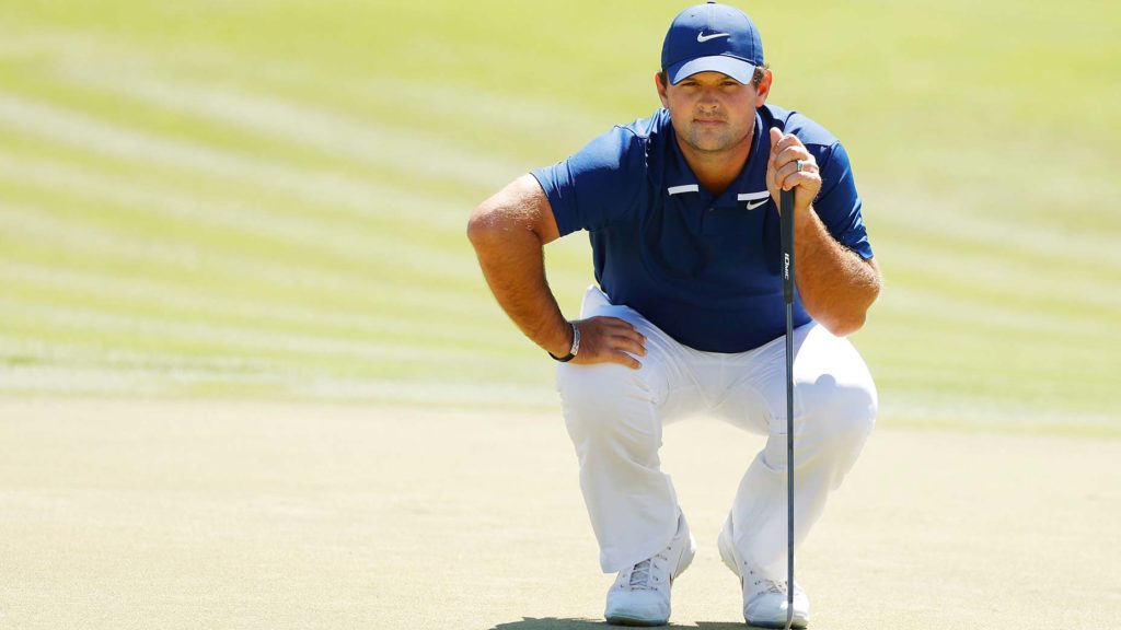 Patrick Reed reads a putt.