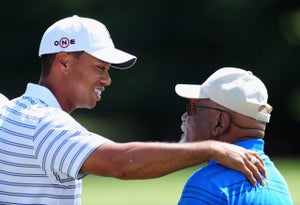 tiger woods with his arm on charlie sifford's shoulder