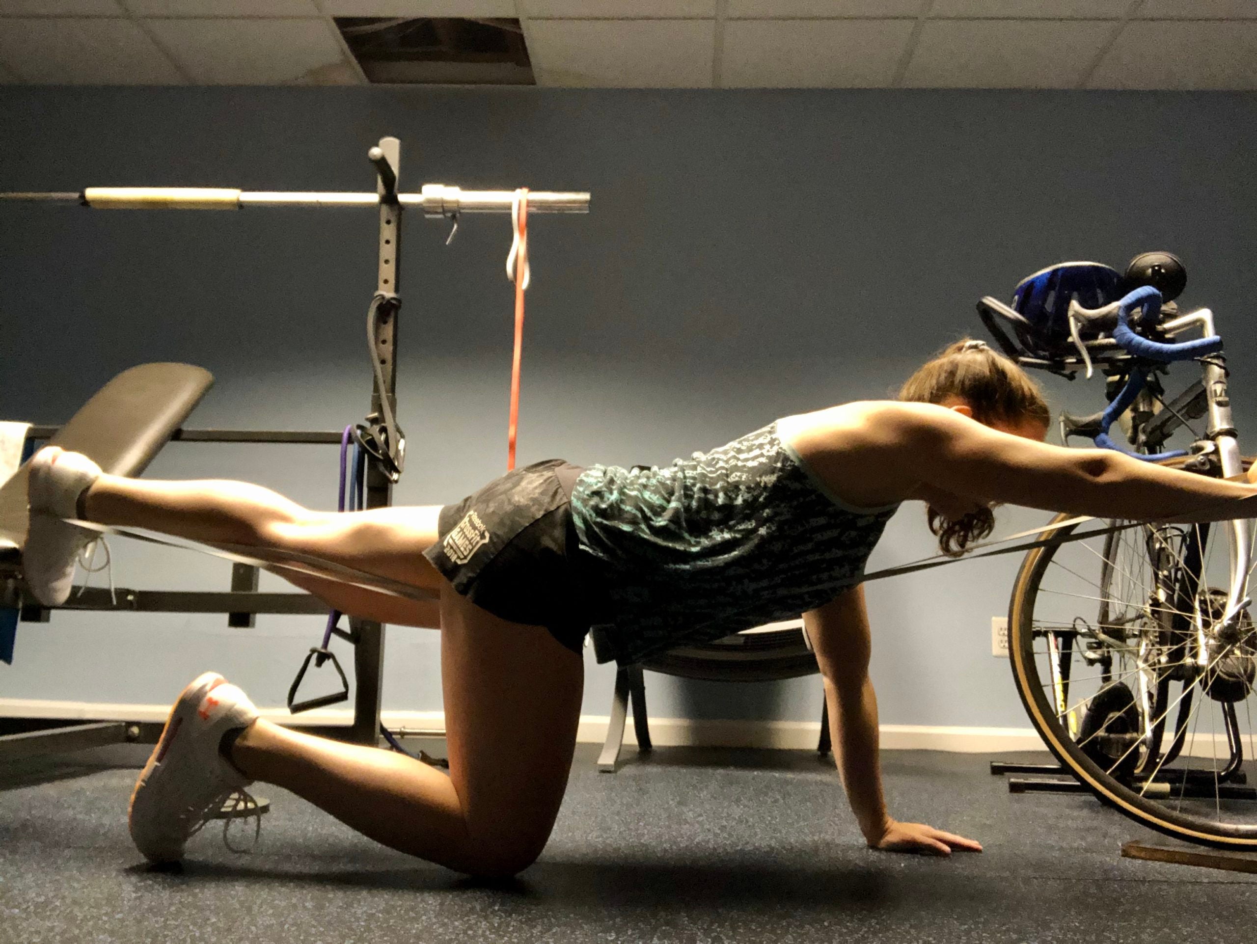 The author performs a band-resisted core exercise.