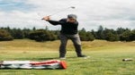 Todd Rohrer swinging next to Macdonald golf bag