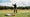 Todd Rohrer swinging next to Macdonald golf bag