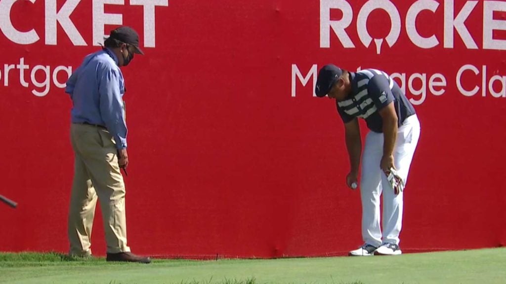 Bryson DeChambeau takes a drop at the Rocket Mortgage Classic.