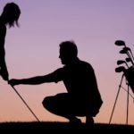 man gives golf swing lesson as sun sets