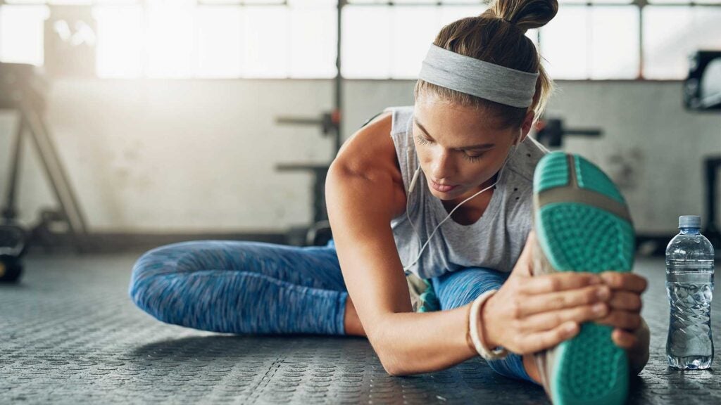 A woman stretches to improve her flexibility.