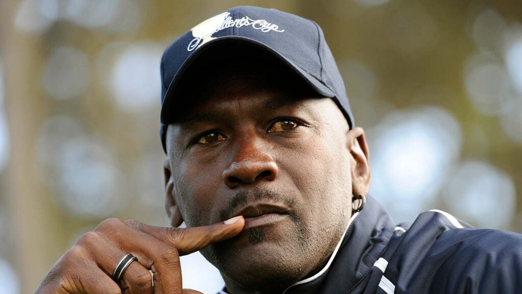 michael jordan stares with presidents cup hat