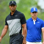 Tiger Woods and Brooks Koepka on the golf course.