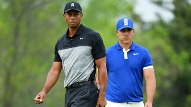 Tiger Woods and Brooks Koepka on the golf course.