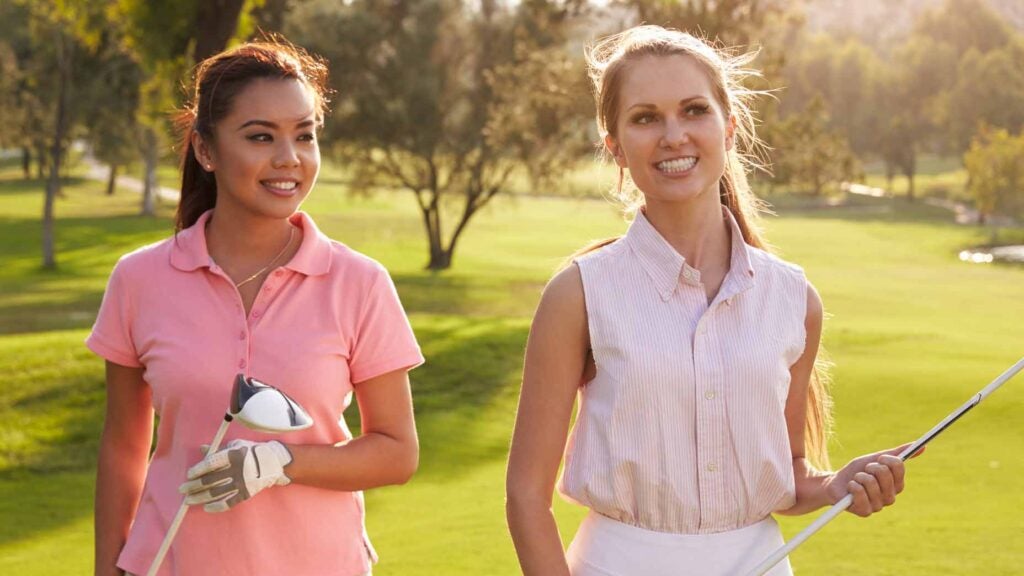 women playing golf