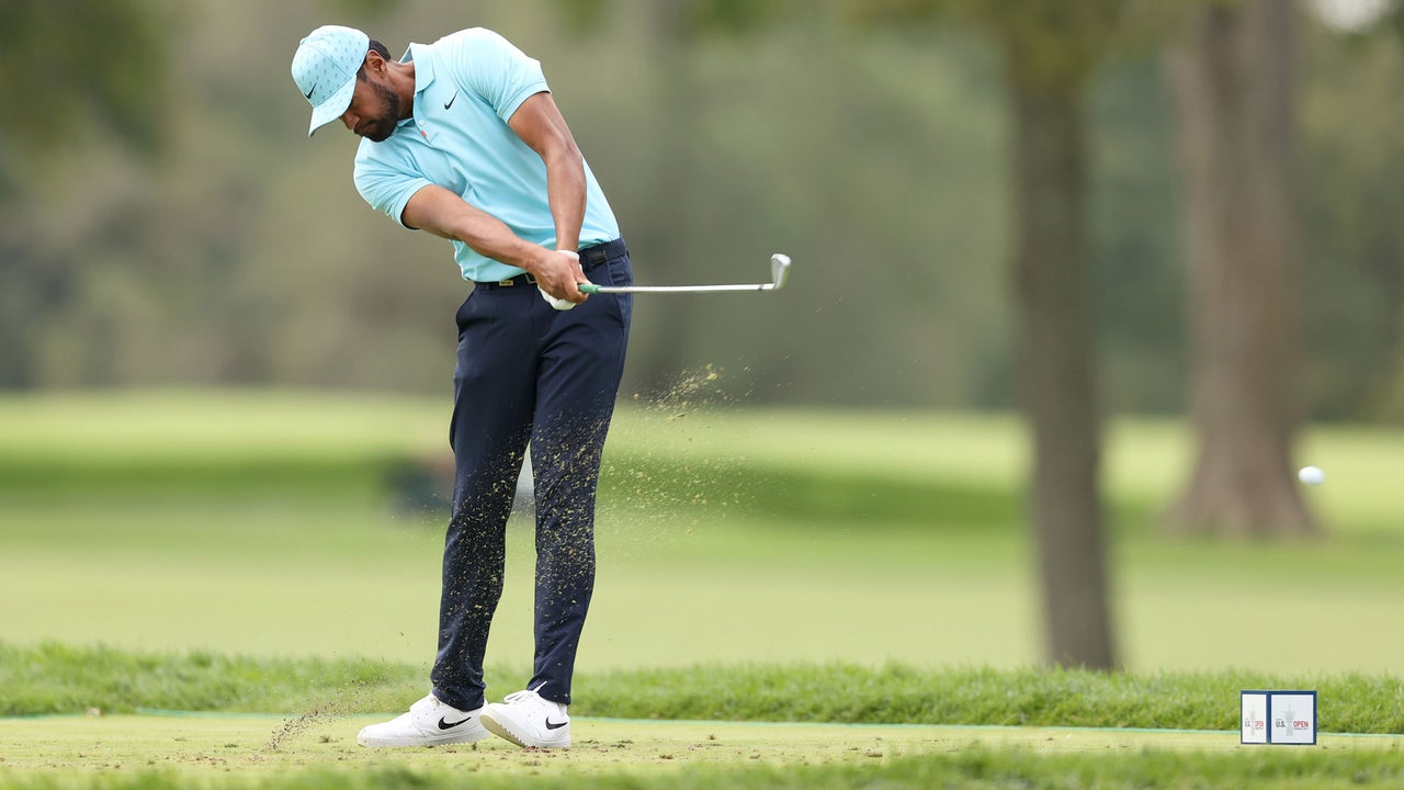 Tony Finau incredibly hits a shot onto the green while slipping