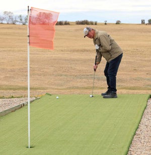 Howard putting at a golf course in Saskatchewan.