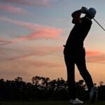 Golfer plays at twilight