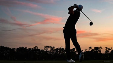 Golfer plays at twilight
