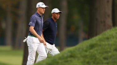 Tiger Woods and Justin Thomas walk.