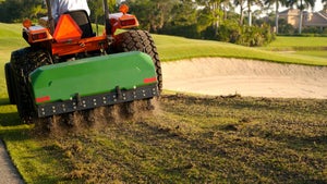 tractor aerating a golf course