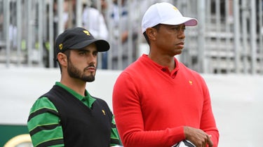 abe ancer stands with tiger woods