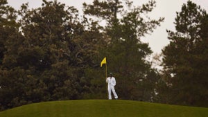 masters caddie holds flag