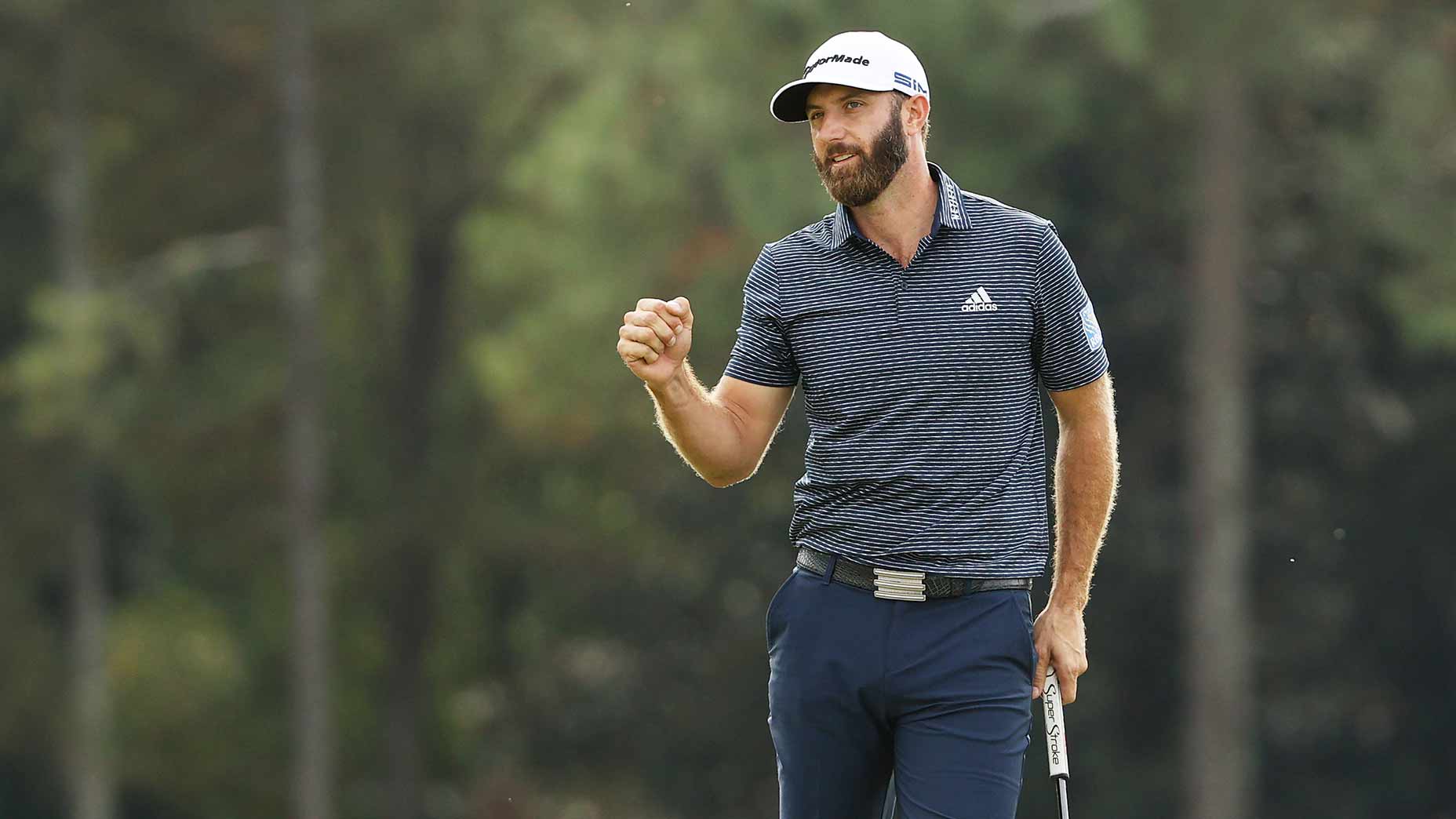 Dustin Johnson fist-pumps.