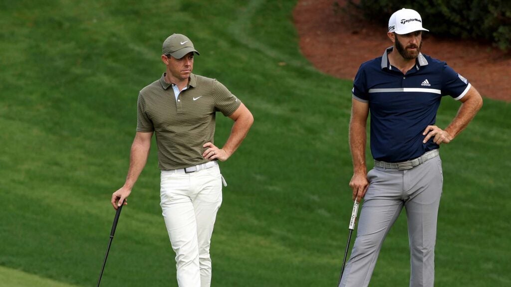 rory mcilroy stands with dustin johnson