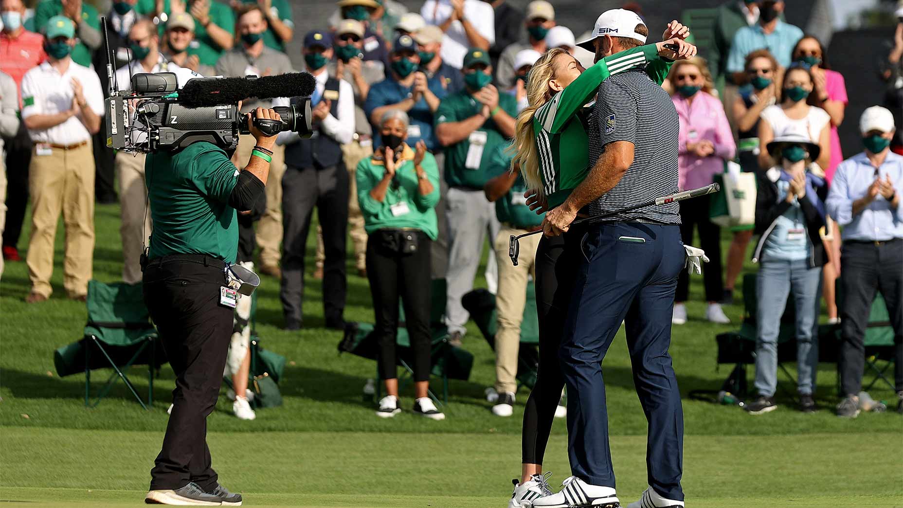 Dustin Johnson and Paulina Gretzky hug.