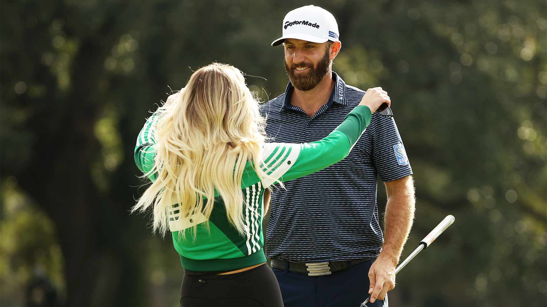 Dustin Johnson and Paulina Gretzky hug.