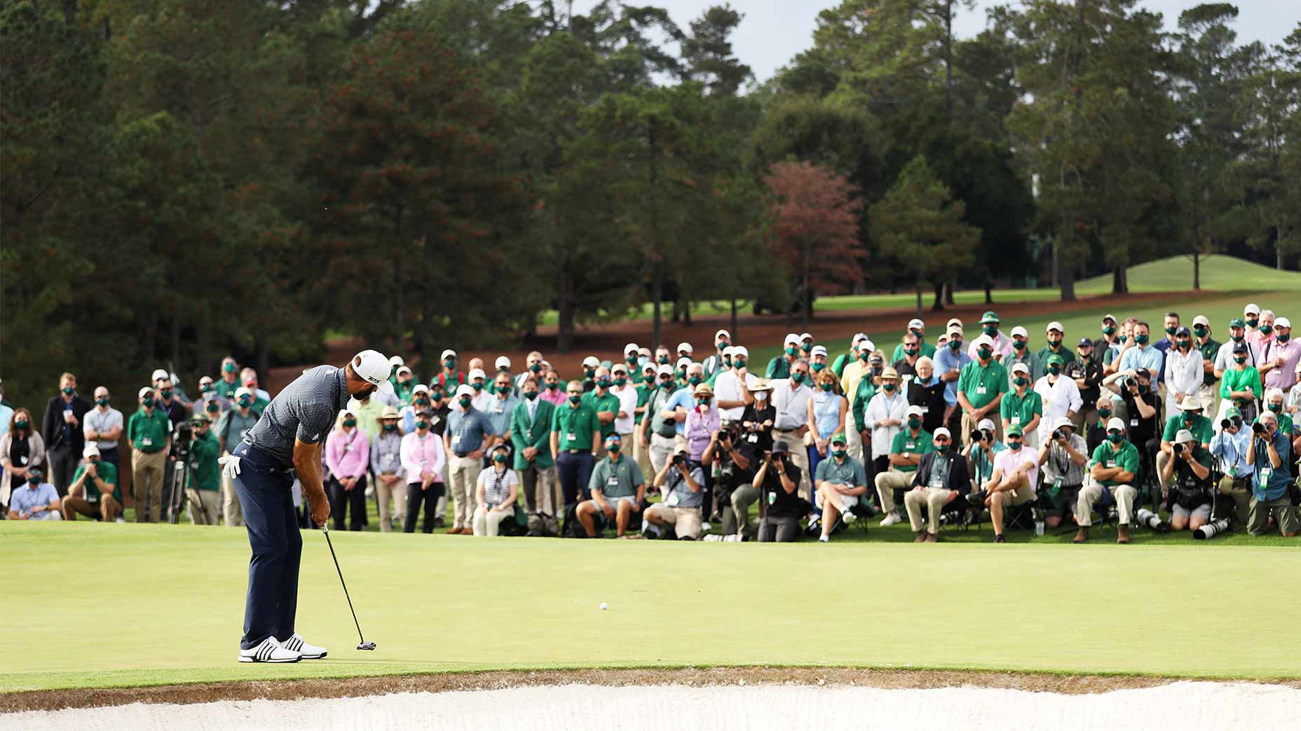 Dustin Johnson putts on the 18th green.