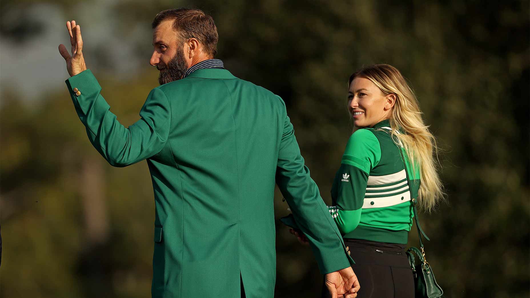 Dustin Johnson and Paulina Gretzky wave.