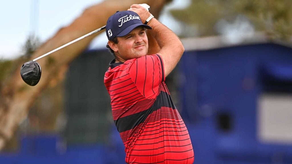Patrick Reed watches a tee shot.