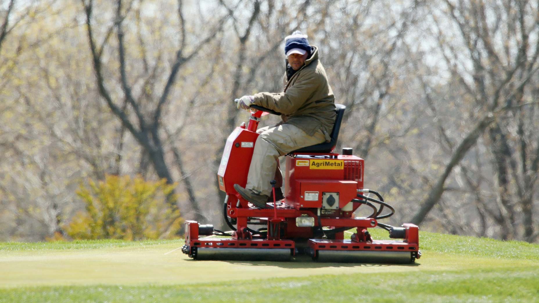 man mows green