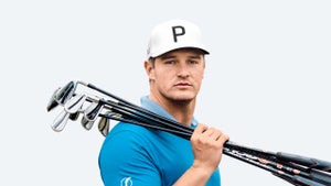 Bryson DeChambeau holds golf clubs.