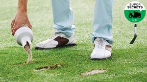 golfer filling divot with sand