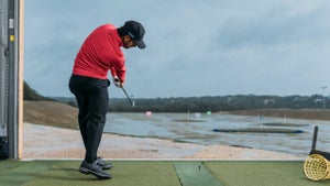 Abraham Ancer sends a 6-iron into the freezing rain at Dead Solid Perfect.