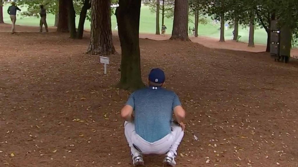 Jordan spieth plays a shot from the trees.