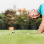 Golfer looking at ball