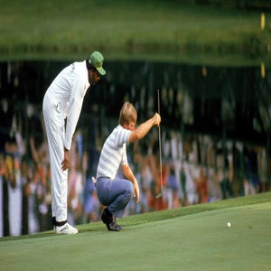 ben crenshaw kneels to read putt during the masters par-3 contest