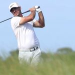 Brooks Koepka swings a golf club
