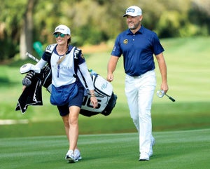 Lee Westwood with fiancee Helen Storey caddying for him.