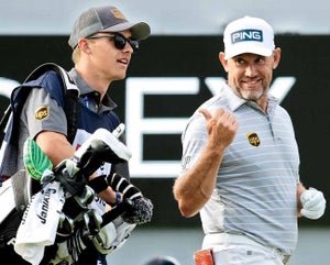 Lee Westwood with is son, Sam, caddying.