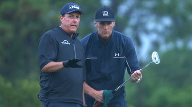Phil mickelson and tom brady read a putt