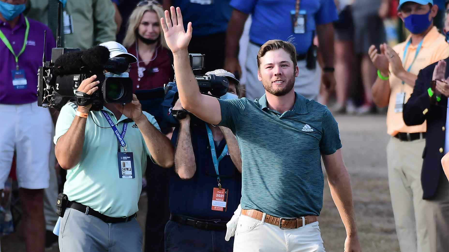 Sam burns waves to the crowd.