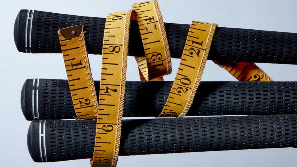 Golf club grips wrapped in measuring tape