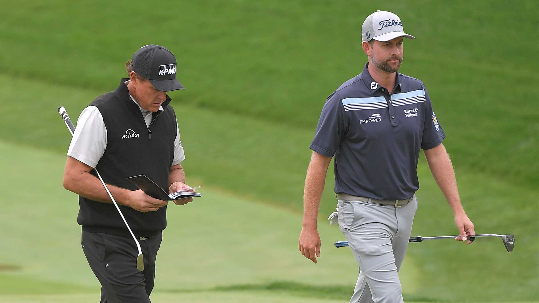 Phil Mickelson and Webb Simpson walk down the fairway