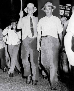 Lloyd Mangrum, being escorted by a USGA official after he won the 1946 U.S. Open.