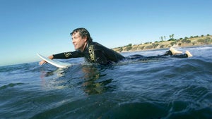 Adam Scott surfing.