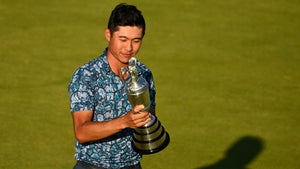 morikawa admires trophy