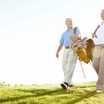 old golfers walk the fairway