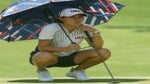 Danielle Kang uses an umbrella to find relief from the heat at Kasumigaseki.